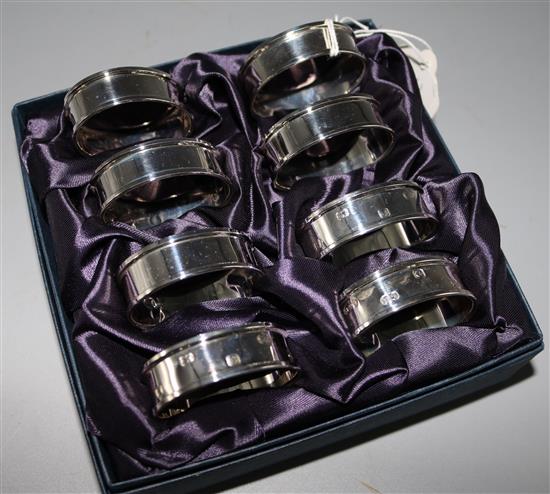 A set of 8 silver serviette rings